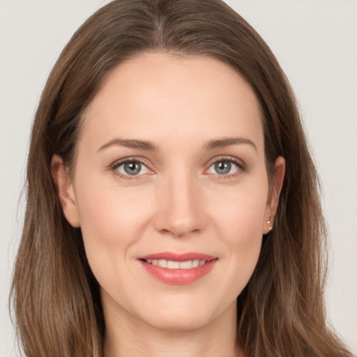 Joyful white young-adult female with long  brown hair and grey eyes