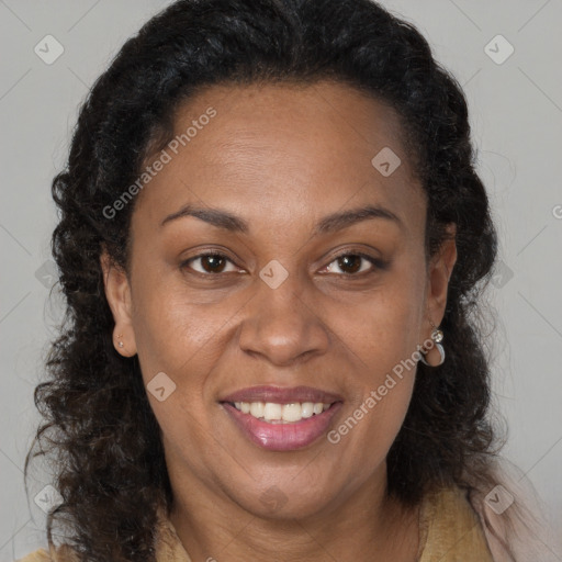 Joyful black adult female with long  brown hair and brown eyes