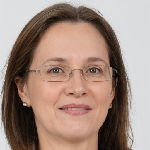 Joyful white adult female with long  brown hair and grey eyes