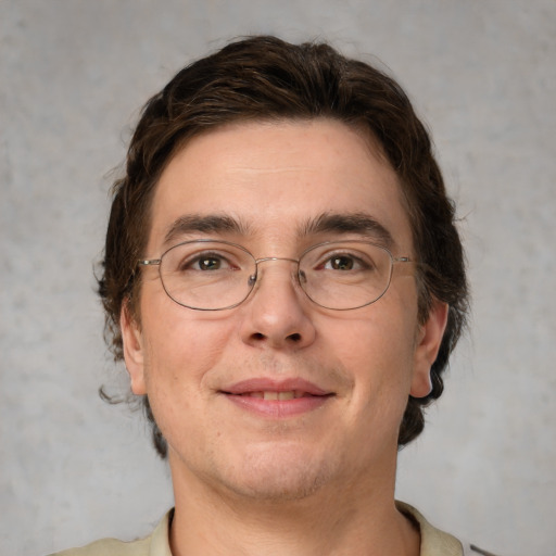 Joyful white adult male with short  brown hair and grey eyes