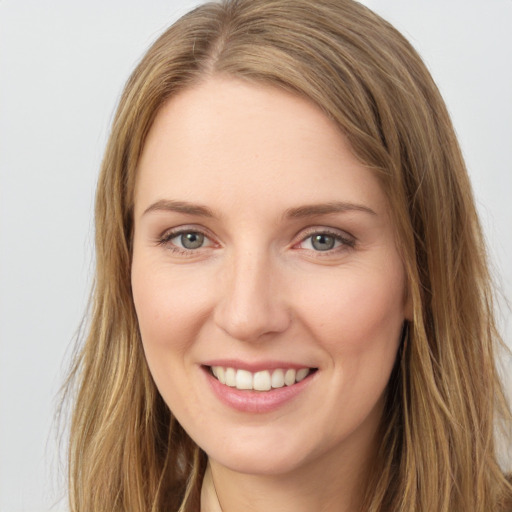 Joyful white young-adult female with long  brown hair and grey eyes