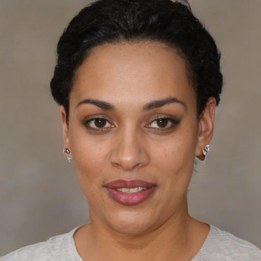 Joyful latino young-adult female with short  black hair and brown eyes