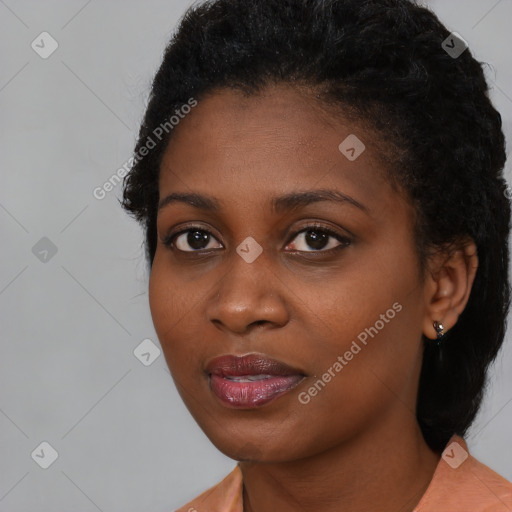 Joyful black young-adult female with medium  black hair and brown eyes