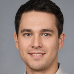 Joyful white young-adult male with short  brown hair and brown eyes