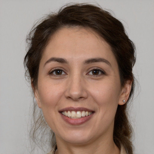 Joyful white young-adult female with medium  brown hair and brown eyes