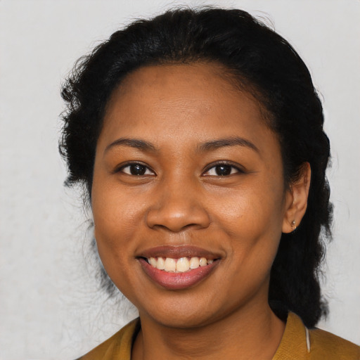 Joyful black adult female with short  black hair and brown eyes