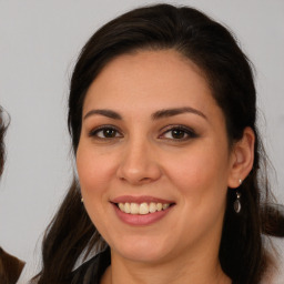 Joyful white young-adult female with medium  brown hair and brown eyes