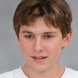 Joyful white child male with short  brown hair and grey eyes