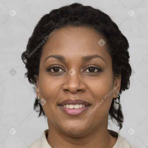 Joyful black adult female with short  brown hair and brown eyes