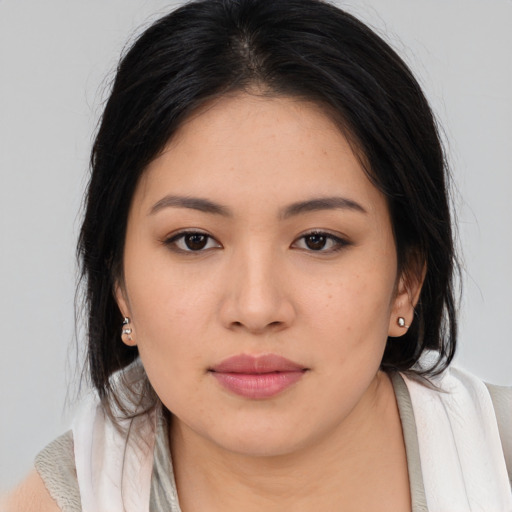 Joyful asian young-adult female with medium  brown hair and brown eyes