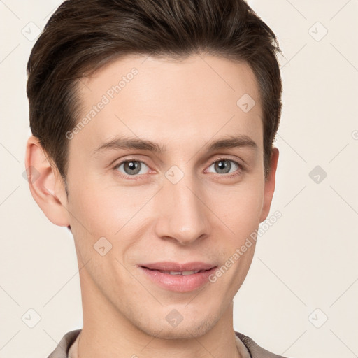 Joyful white young-adult male with short  brown hair and grey eyes