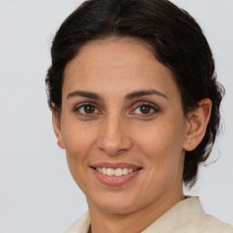 Joyful white adult female with medium  brown hair and brown eyes