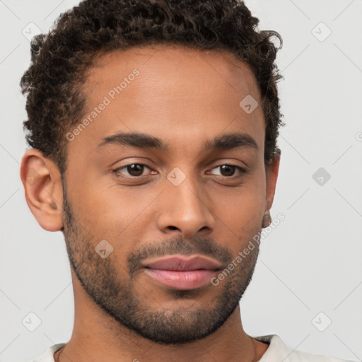 Joyful black young-adult male with short  brown hair and brown eyes