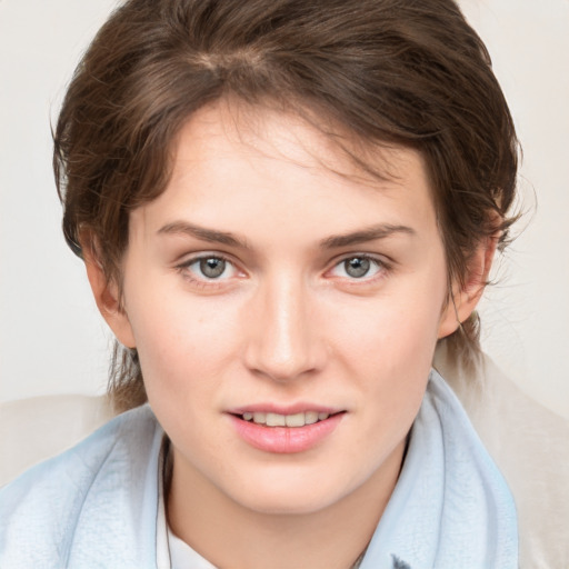 Joyful white young-adult female with medium  brown hair and blue eyes