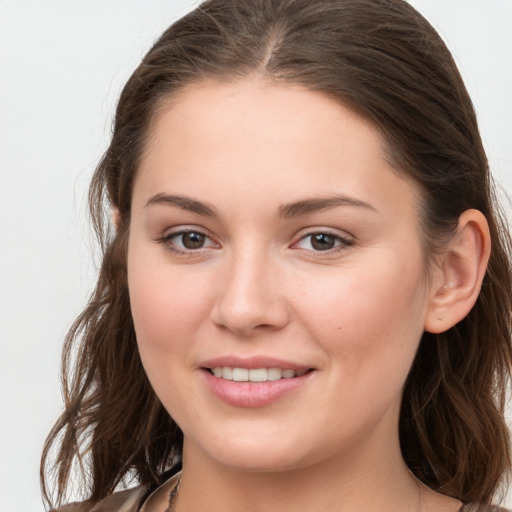 Joyful white young-adult female with long  brown hair and grey eyes