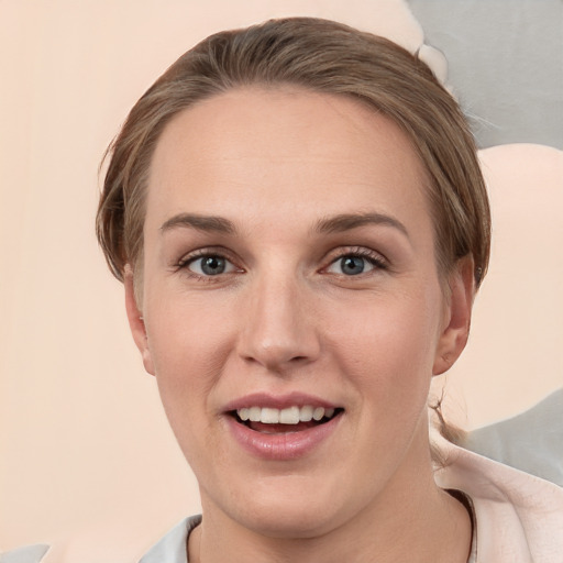 Joyful white young-adult female with short  brown hair and grey eyes