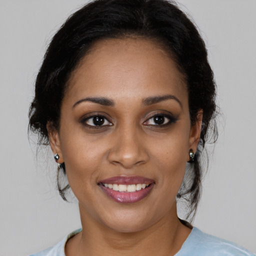 Joyful black young-adult female with medium  black hair and brown eyes
