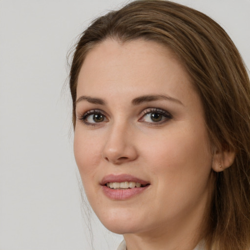 Joyful white young-adult female with long  brown hair and brown eyes