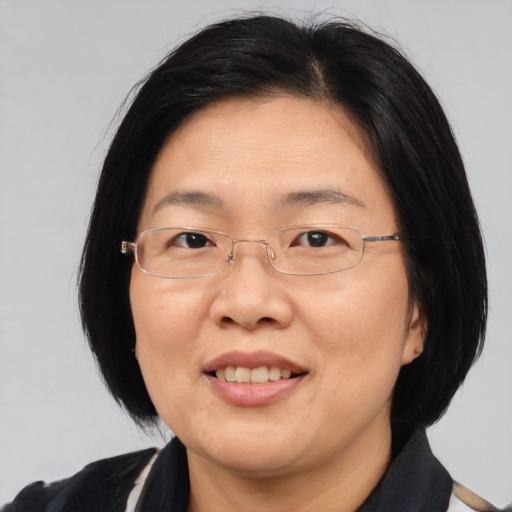 Joyful asian adult female with medium  brown hair and brown eyes