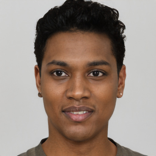 Joyful black young-adult male with short  black hair and brown eyes