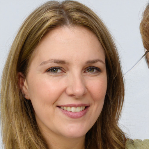 Joyful white adult female with long  brown hair and brown eyes