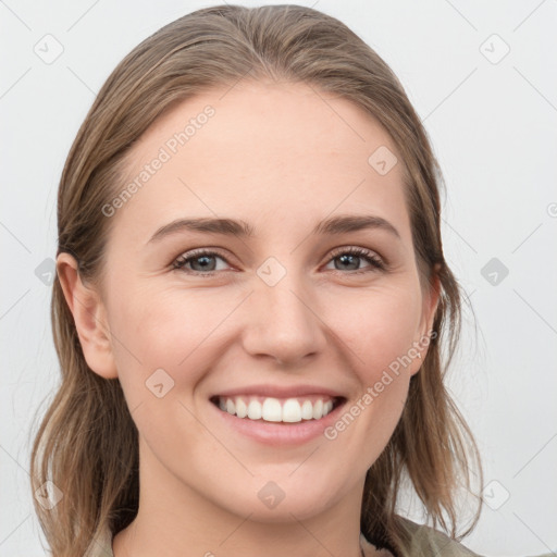 Joyful white young-adult female with medium  brown hair and grey eyes