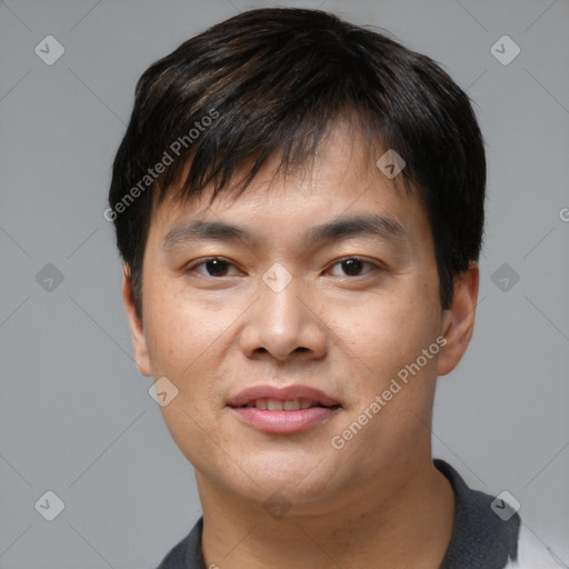 Joyful asian young-adult male with short  brown hair and brown eyes