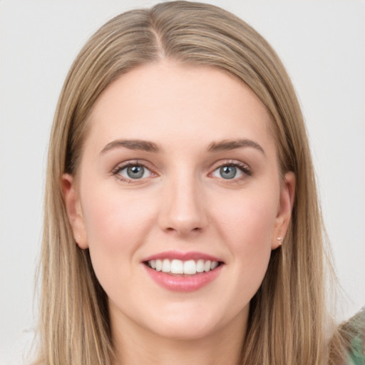 Joyful white young-adult female with long  brown hair and grey eyes