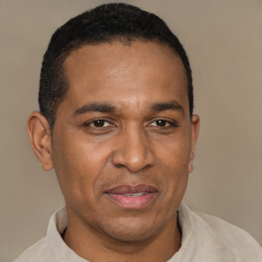 Joyful latino adult male with short  brown hair and brown eyes