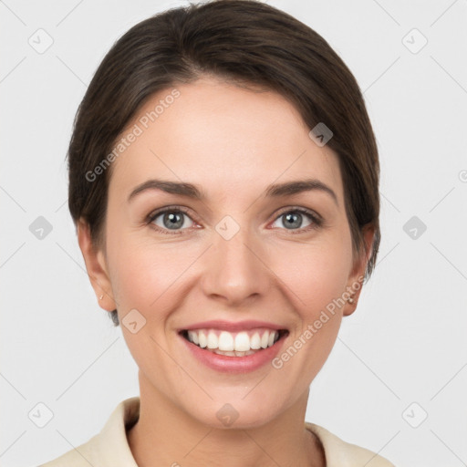 Joyful white young-adult female with short  brown hair and grey eyes