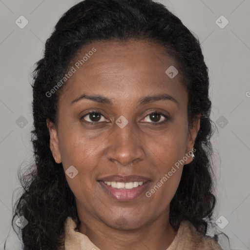 Joyful black adult female with long  brown hair and brown eyes