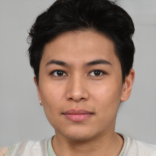 Joyful asian young-adult male with short  black hair and brown eyes