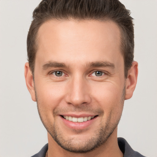 Joyful white young-adult male with short  brown hair and brown eyes