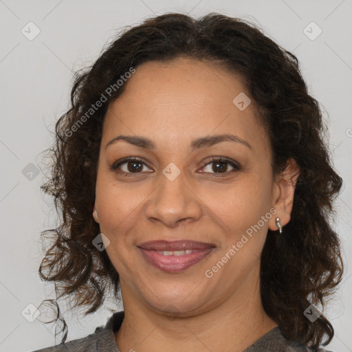 Joyful black adult female with medium  brown hair and brown eyes