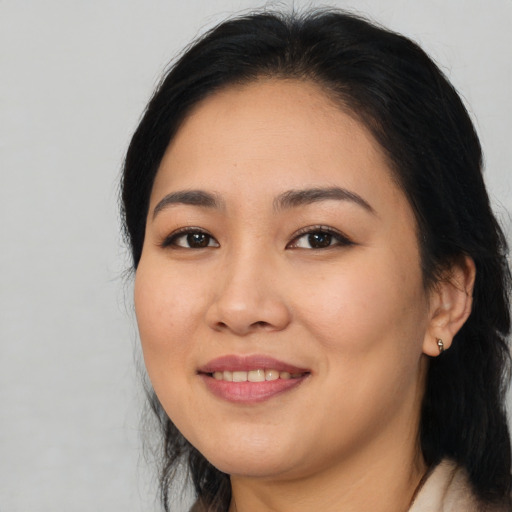 Joyful asian young-adult female with long  black hair and brown eyes