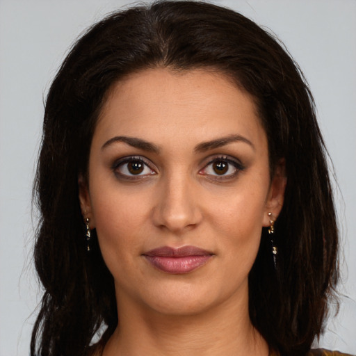 Joyful white young-adult female with long  brown hair and brown eyes