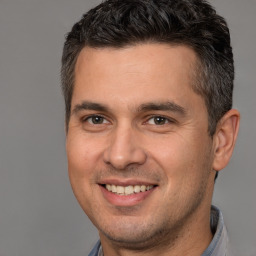 Joyful white adult male with short  brown hair and brown eyes