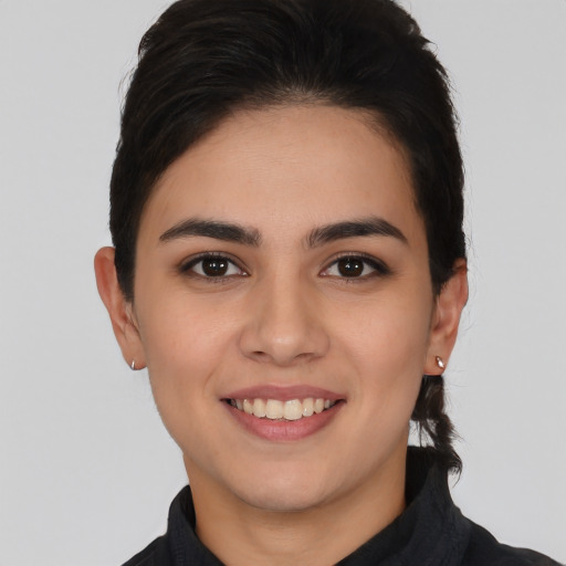 Joyful white young-adult female with short  black hair and brown eyes