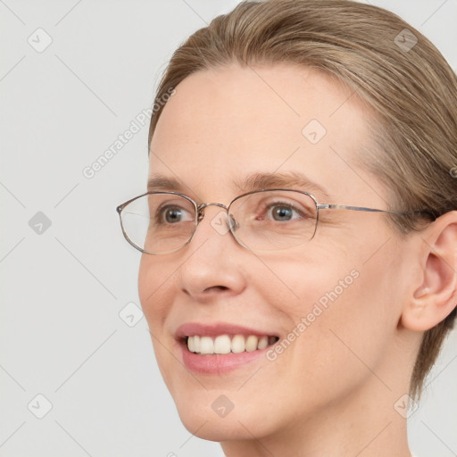 Joyful white adult female with medium  brown hair and blue eyes