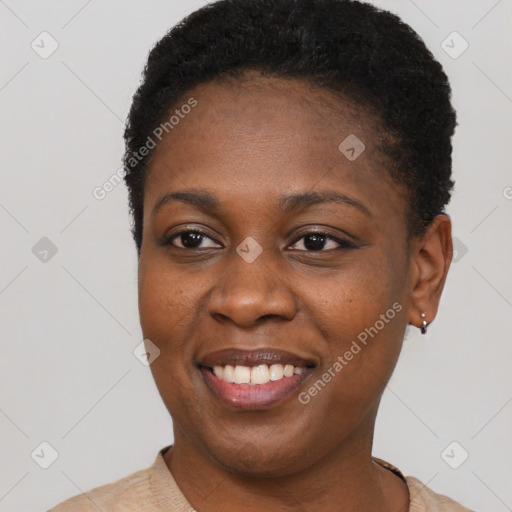 Joyful black young-adult female with short  black hair and brown eyes