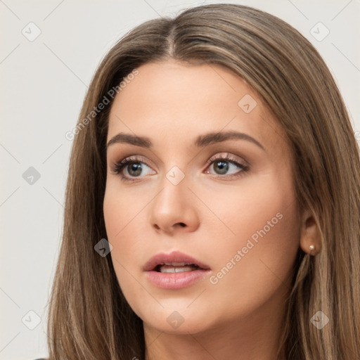 Neutral white young-adult female with long  brown hair and brown eyes