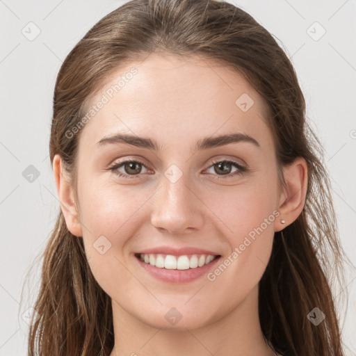 Joyful white young-adult female with long  brown hair and grey eyes