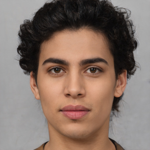 Joyful latino young-adult male with short  brown hair and brown eyes
