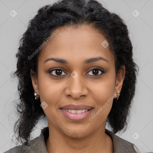 Joyful black young-adult female with long  brown hair and brown eyes