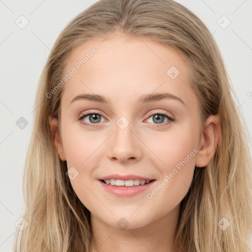 Joyful white young-adult female with long  brown hair and blue eyes