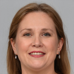 Joyful white adult female with long  brown hair and grey eyes