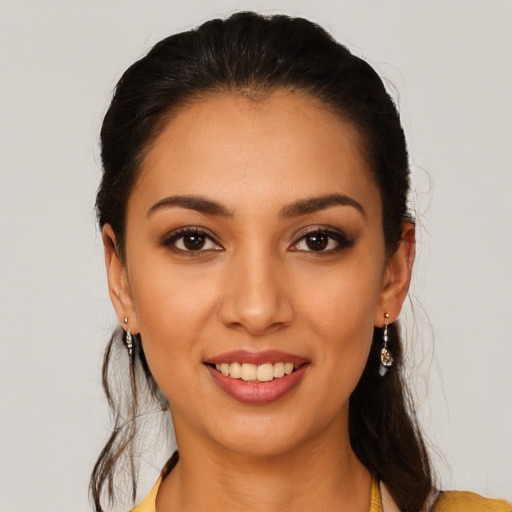 Joyful latino young-adult female with long  brown hair and brown eyes