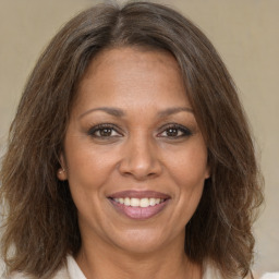 Joyful white adult female with medium  brown hair and brown eyes