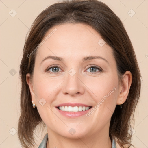 Joyful white young-adult female with medium  brown hair and grey eyes