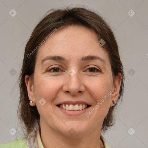 Joyful white adult female with medium  brown hair and grey eyes